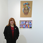 Theresa in front of Headwrap Text & Politics exhibition